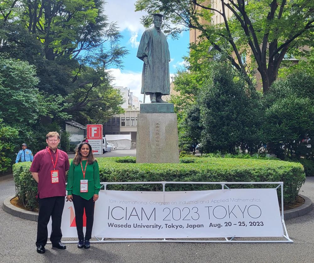 Bokil and Gibson stand next to a statue at Waseda